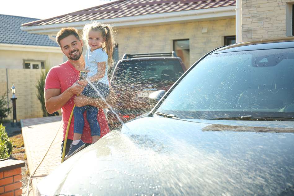 What is life insurance? - father carrying his daughter washing a car