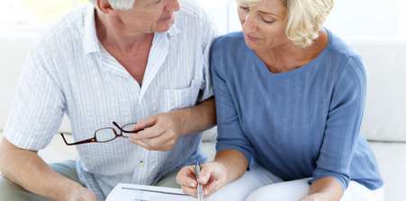 Two pensioners looking over paperwork - what is pension drawdown