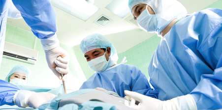 3 surgeons over a patient