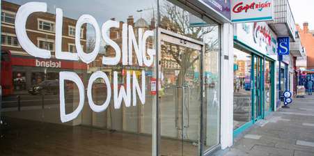 a shop with the words " closing down" written on the window