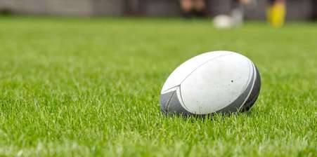 Rugby ball lying upon a rugby pitch