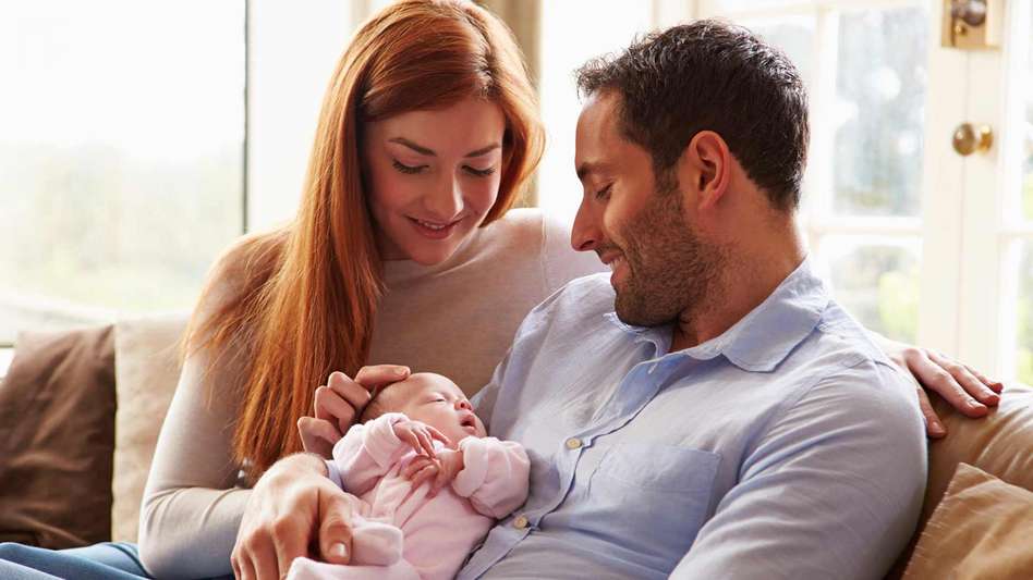 new couple holding their baby after forceps delivery complications traumatic forceps delivery