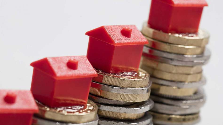 pound coins and toy houses illustrating inheritance tax