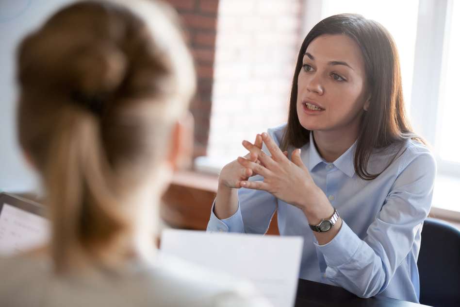 Two employees around a desk looking serious - employment tribunal