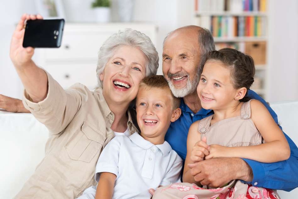 Grandparents taking a selfie with their grandchildren