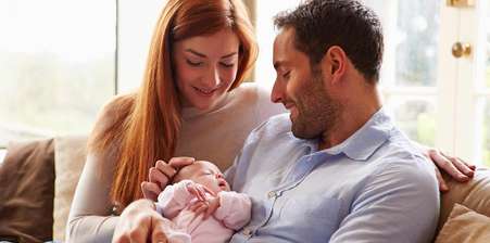 new couple holding their baby after forceps delivery complications