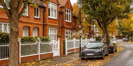 Suburban London street with cars parked on the road