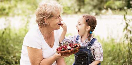 grandparents rights - grandaughter putting a cherry into her grandmother's mouth