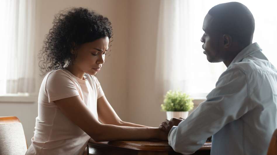 Couple sitting facing each other