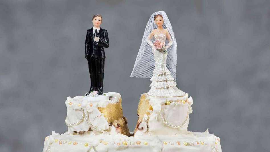 Wedding cake with a divide between the bride and groom