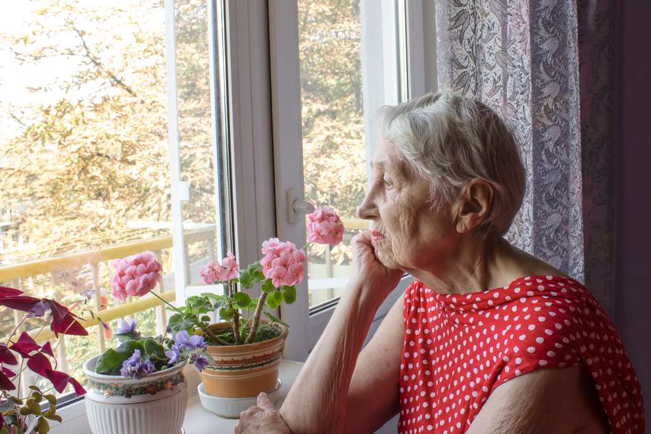 Picture of older lady looking out the window