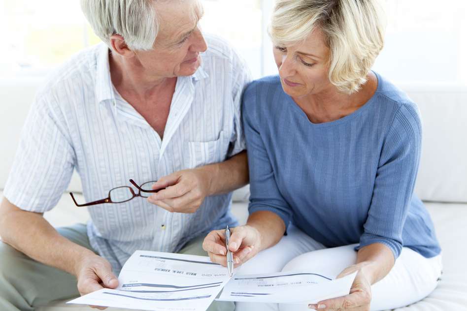Two pensioners looking over paperwork - what is pension drawdown