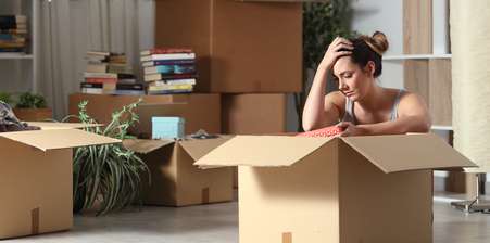 woman sittingamongst moving boxes