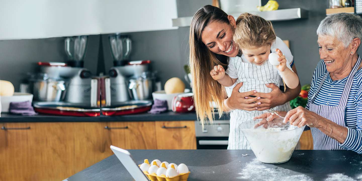 Mother, daughter and grandmother baking in a modern kitchen