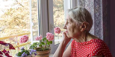 Picture of older lady looking out the window
