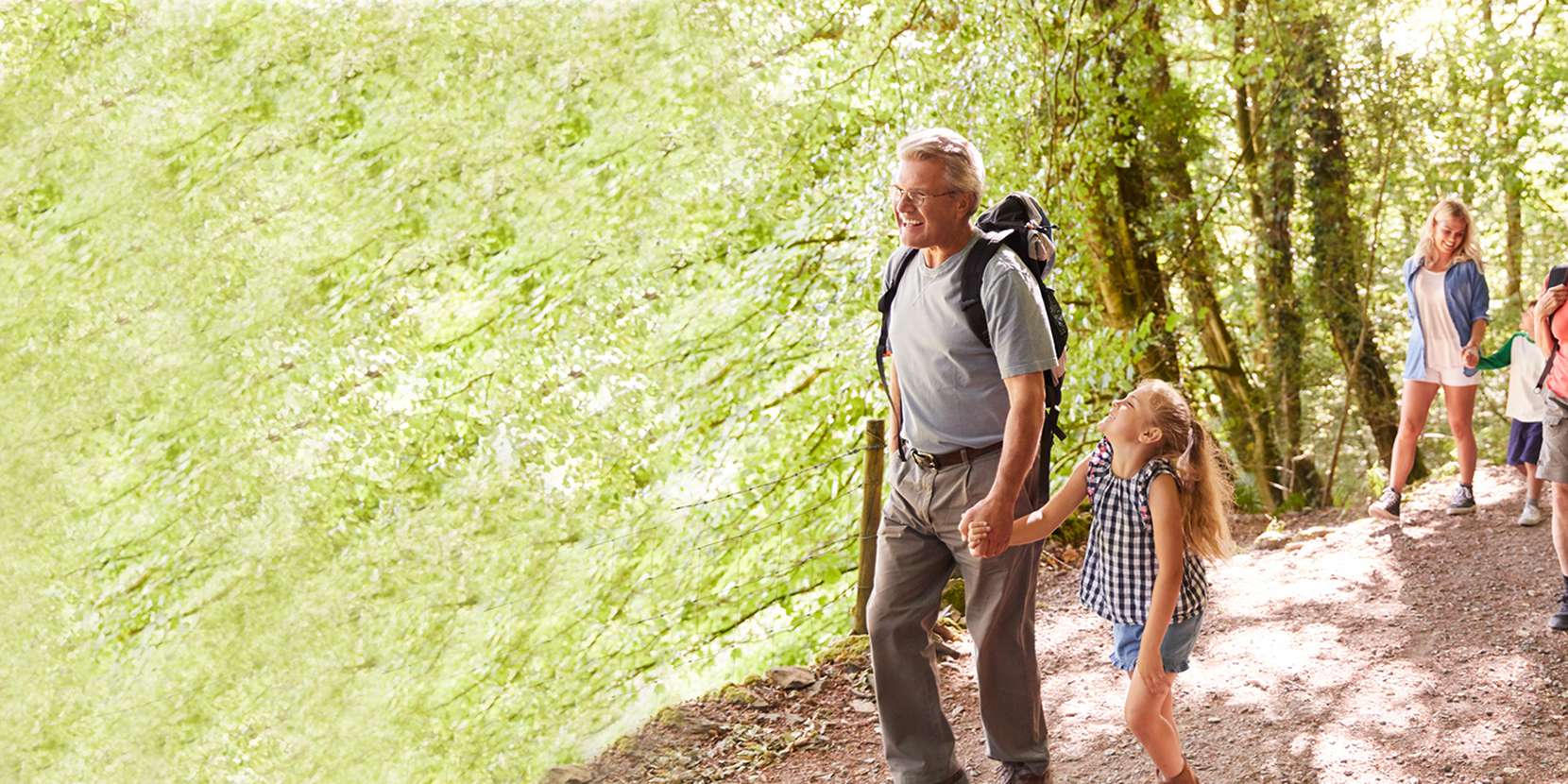 Family walking along a nature trail with their grandparents