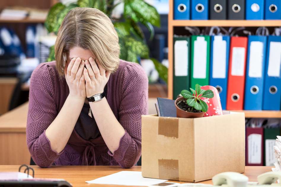 a women crying at her desk after being made redundant