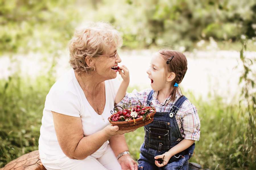 grandparents rights - grandaughter putting a cherry into her grandmother's mouth