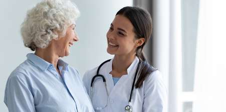 A doctor advising an older patient - article on critical illness or income protection insurance